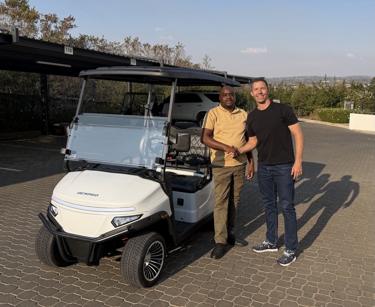 Customer handover beside a white golf cart