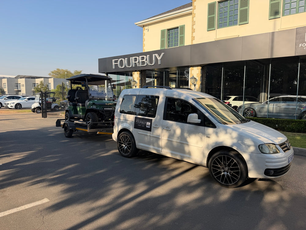 Fourbuy Cart Co branded vehicle and golf cart trailer outside the showroom