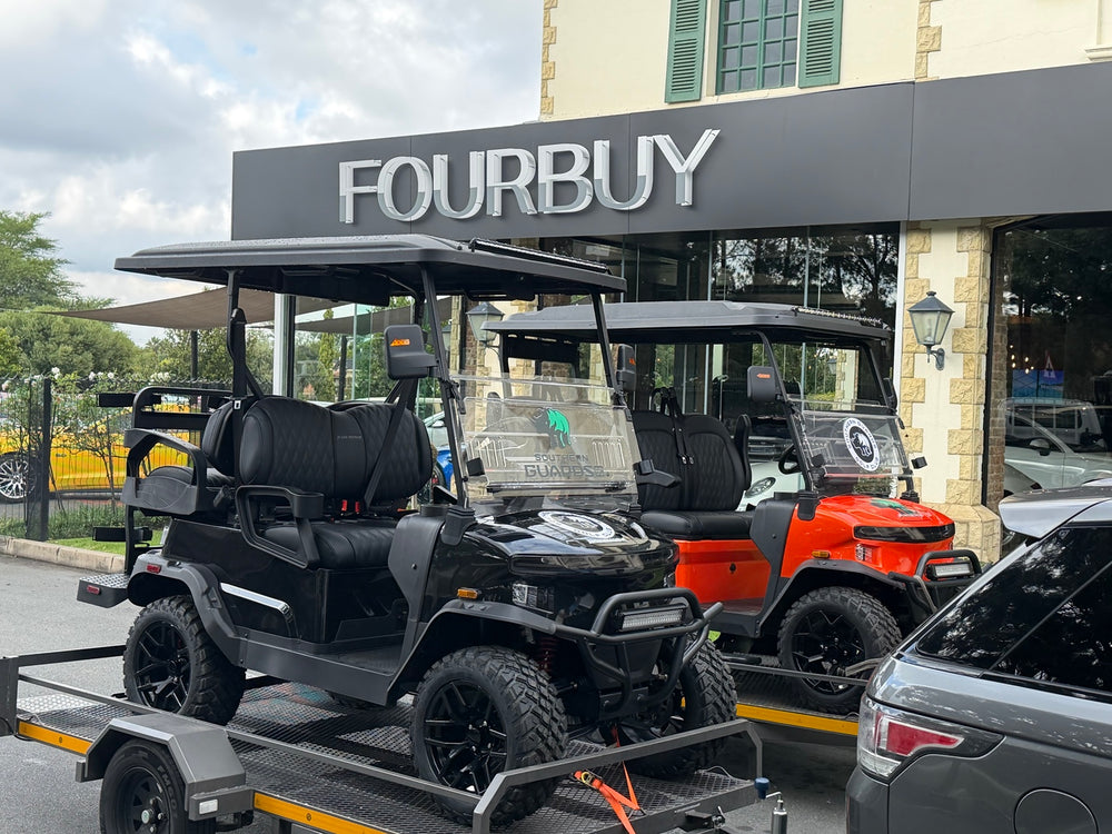 A golf cart secured on a trailer outside the Fourbuy showroom