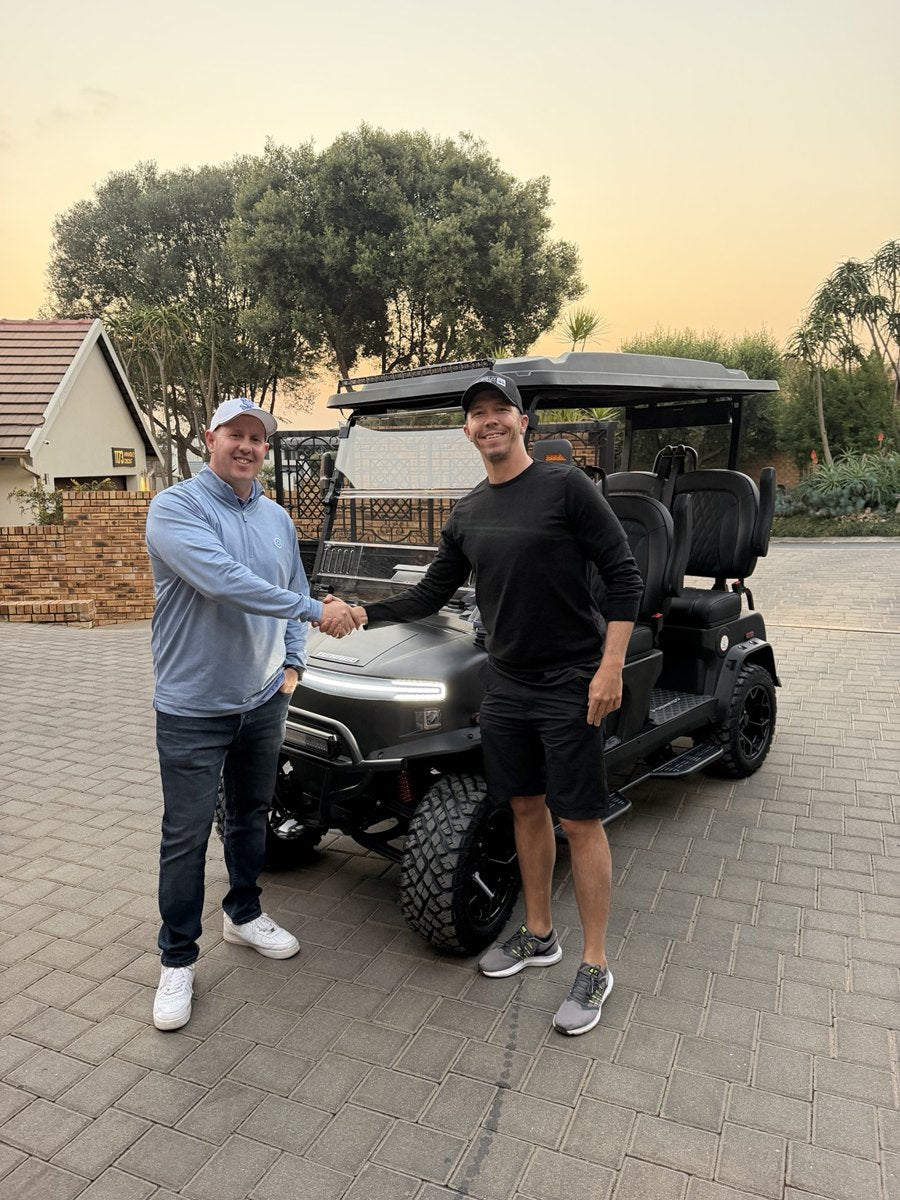 Customer handover beside a Denago cart