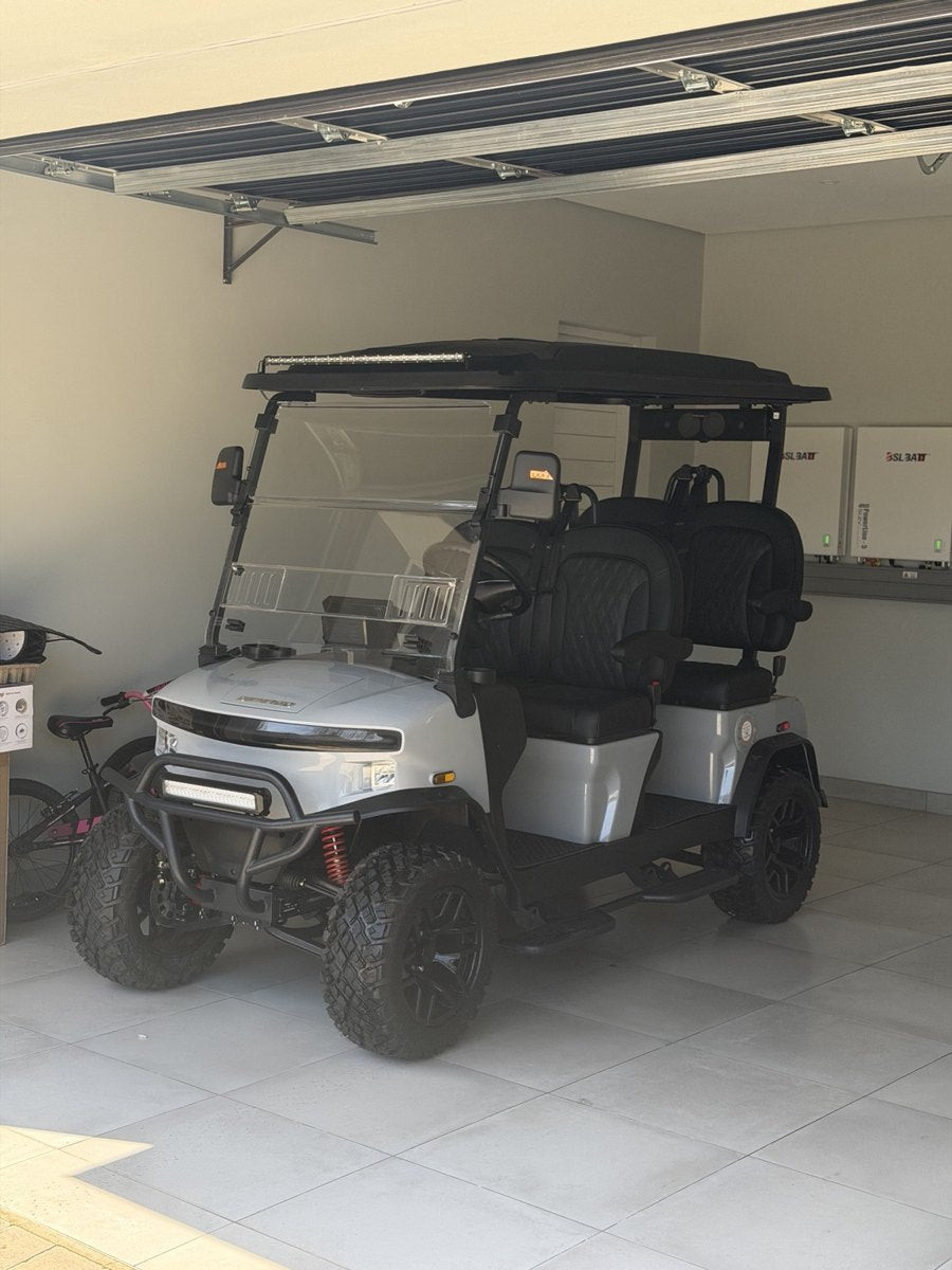 White Denago cart parked in a garage