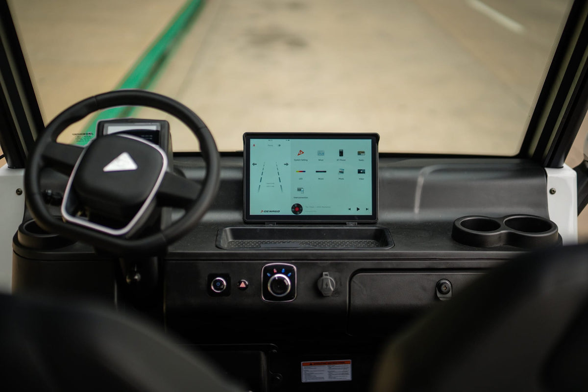 Denago City steering wheel, driver display and central touchscreen viewed from inside the cabin