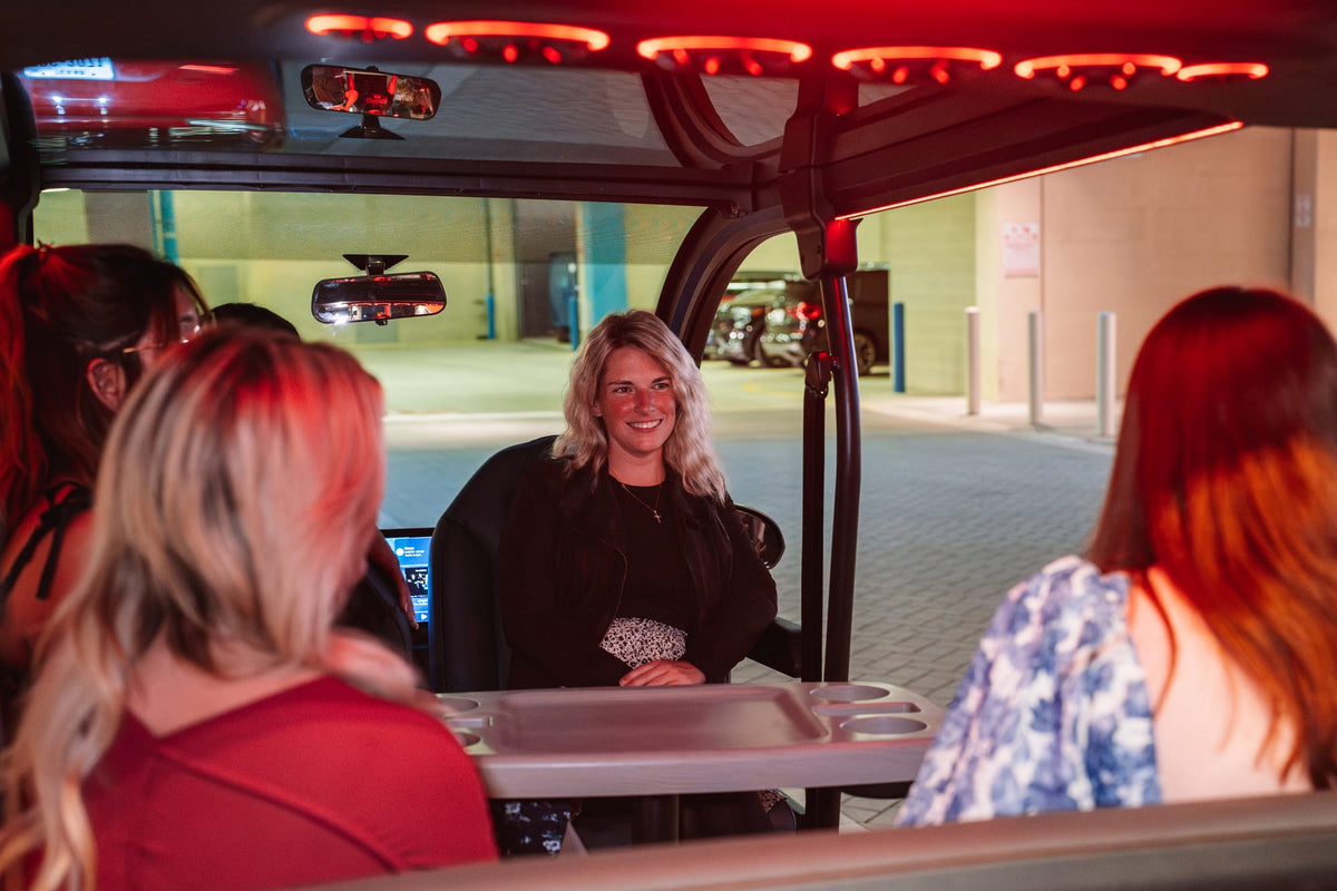 Friends chatting around the table inside a Denago City with warm interior lighting