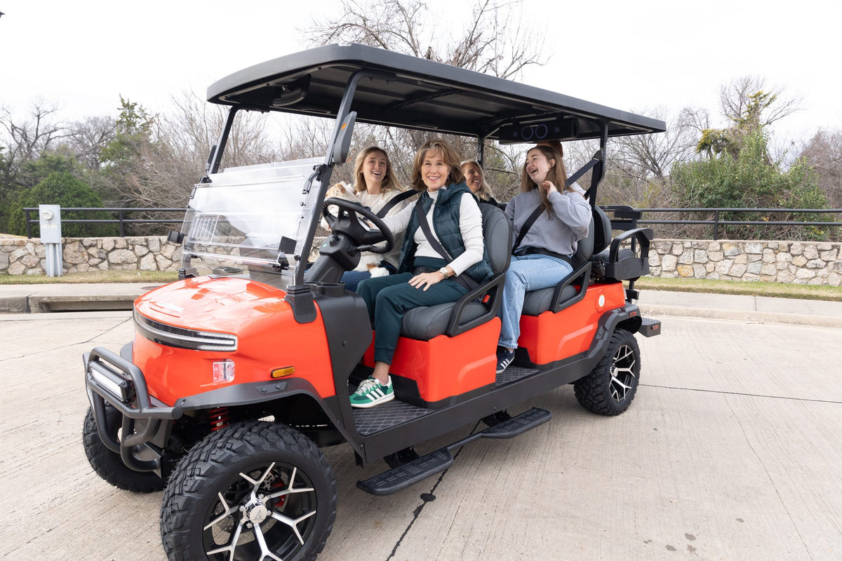Orange Denago Rover XL-6 with friends seated in its two forward-facing passenger rows