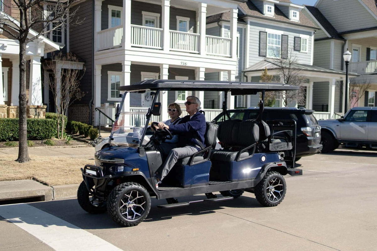 Blue Denago Rover XL-6 with a couple enjoying a neighbourhood drive