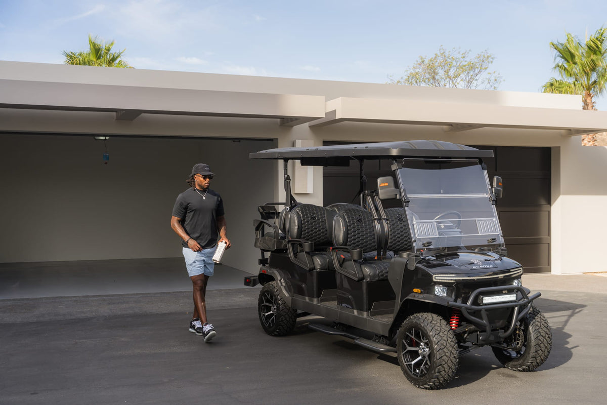 Black Denago Rover XL-6 parked outside a modern home with its owner nearby