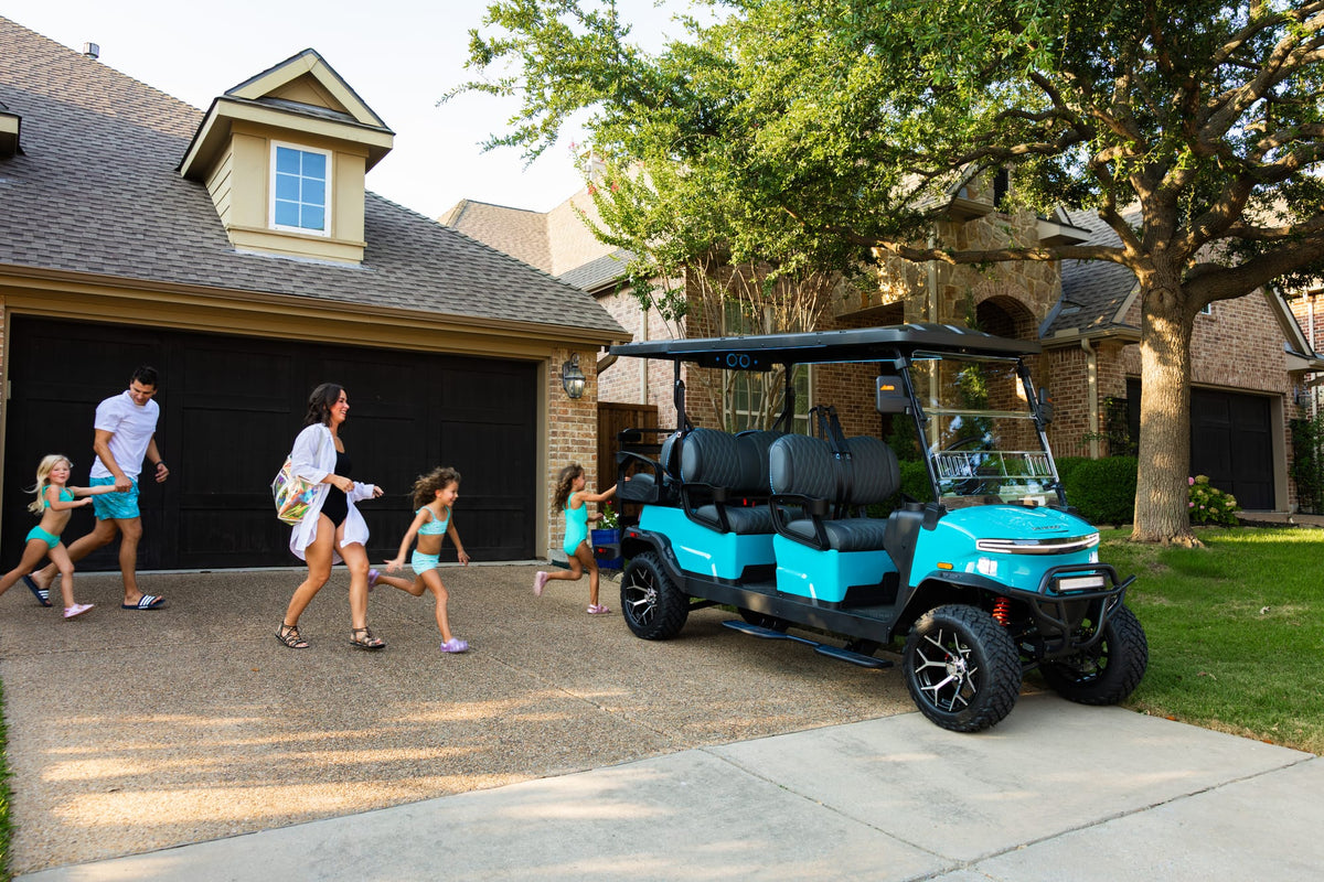 Family walking towards an aqua Denago Rover XL-6 outside their home