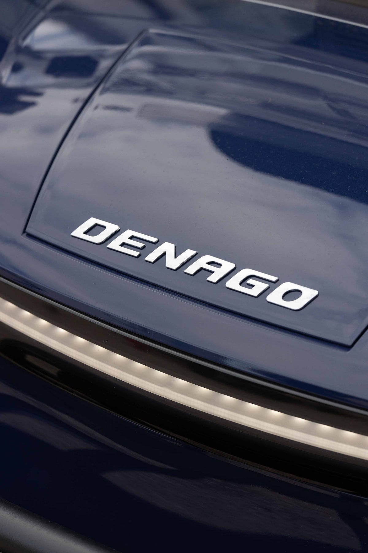 Denago badge and front light styling on a blue Rover XL