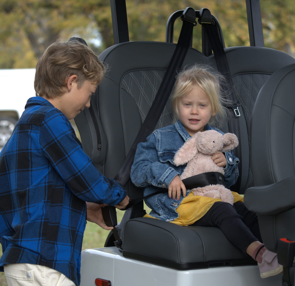 Children preparing for an outing in the forward-facing seats of a Denago Rover XXL