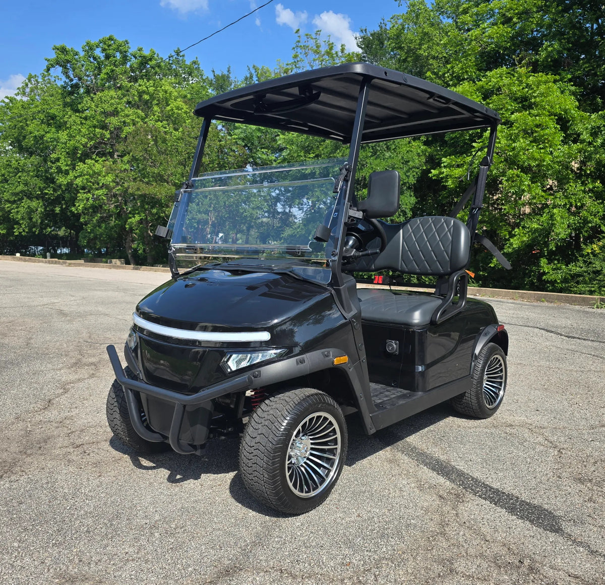 Black Denago Scout 2 viewed from the front with trees in the background