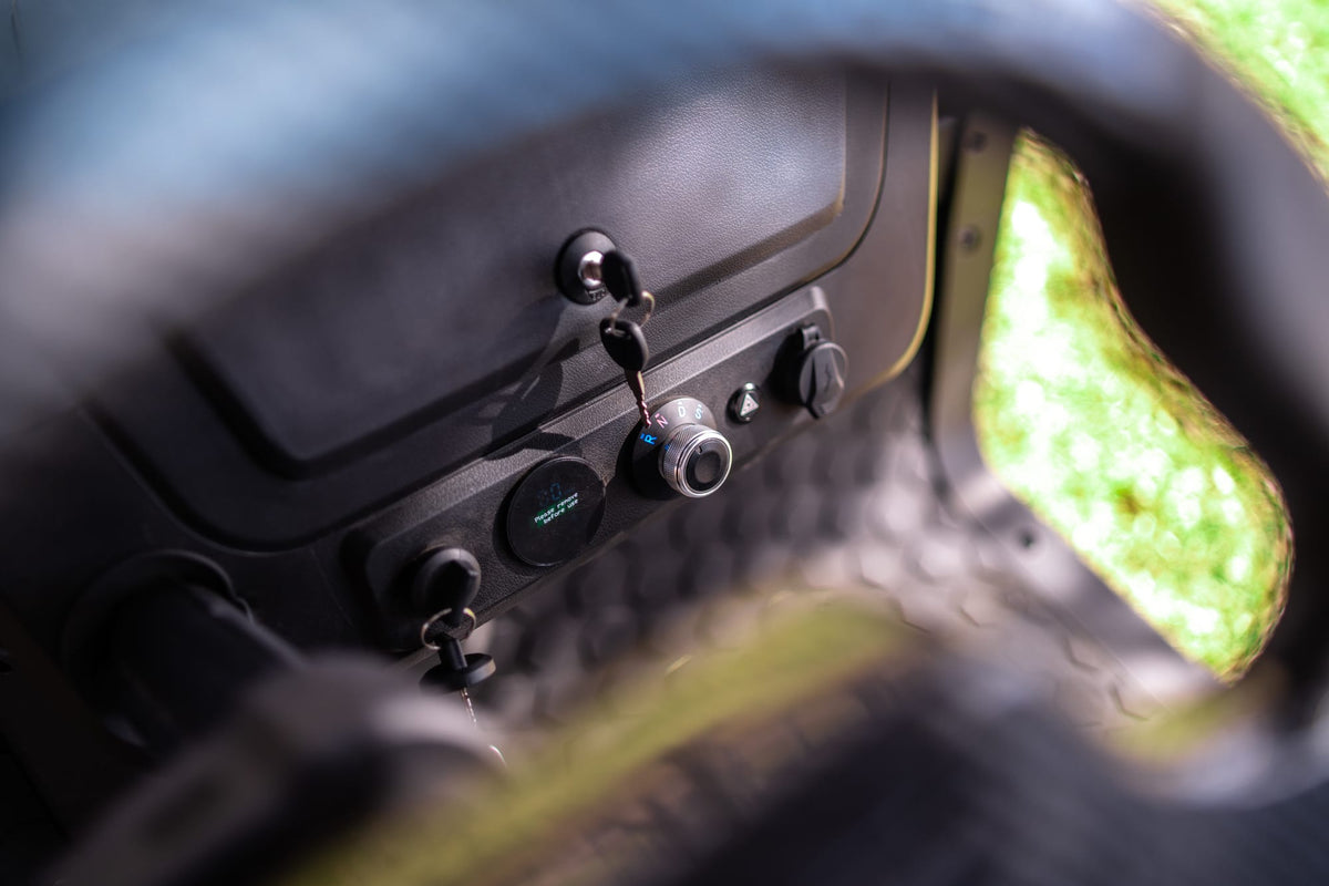 Denago Scout 2 dashboard controls and key viewed through the steering wheel