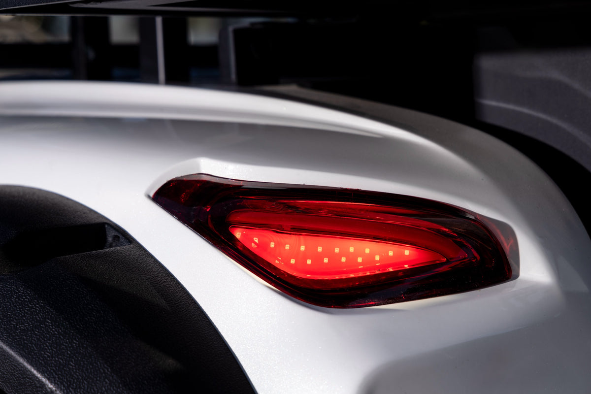 Illuminated red Smart Cart rear light set into white bodywork